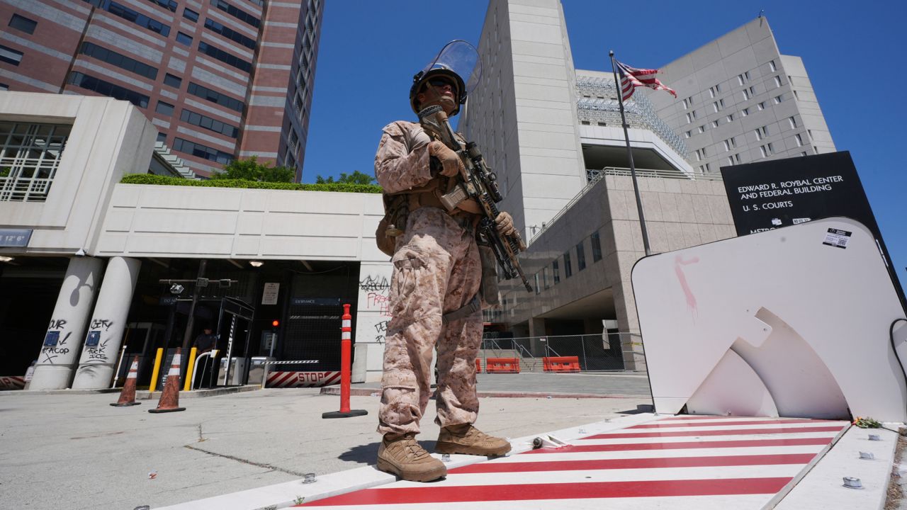 U.S. Marines guard the Edward R. Roybal Federal Building on Monday in Los Angeles. (AP Photo/Damian Dovarganes)