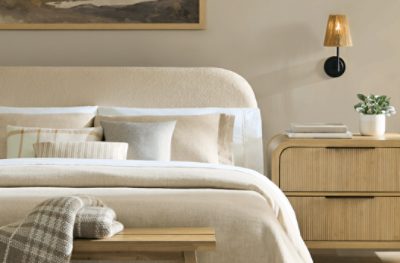 Bedroom painted in SW 9173 Shiitake, neutral bedding and nightstands, minimal decor.